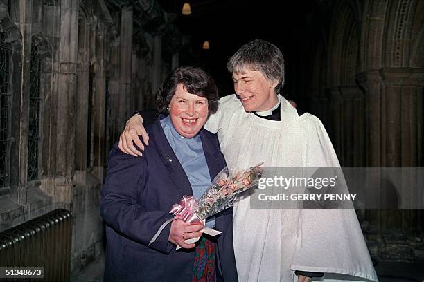 Newly ordained women priests Christine Clarke and Carol Edwards hug each inside Bristol Cathedral 12 March 1994 after the historic ordination...