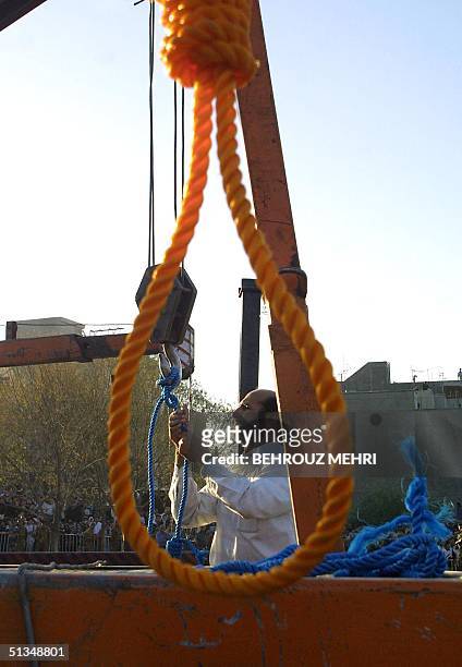 An Iranian judiciary staff ties ropes prior to the execution of Majid Ghasemi, Amir Fakhri, and Payam Amini in east Tehran 29 September 2002....