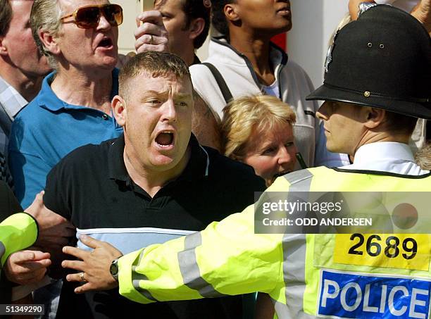 Police holds back an angry mob, screaming abuse, as the convoy carrying suspect Maxine Carr leaves the Peterborough magistrates court, some 90 miles...