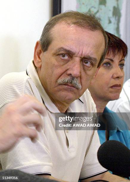 Palestinian Information Minister Yasser Abed Rabbo looks at former Israeli justice minister and one of the architects of the Oslo agreement Yossi...