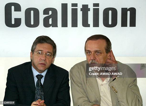 Former Israeli justice minister and one of the architects of the Oslo agreement Yossi Beilin sits with Palestinian Information Minister Yasser Abed...