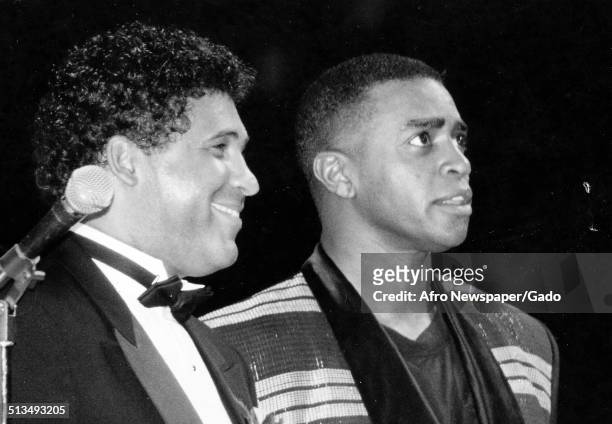 Greg Gumbel and Ahmad Rashad standing at a United Negro College Fund event, 1980.