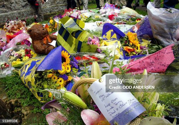 Farewell note to Holly Wells and Jessica Chapman lies with flowers put down in their memory outside the Church in the Cambridgeshire village of Soham...