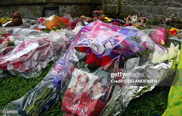 Picture of murdered schoolgirls Holly Wells and Jessica Chapman lies with flowers put down in their memory outside the Church in the Cambridgeshire...