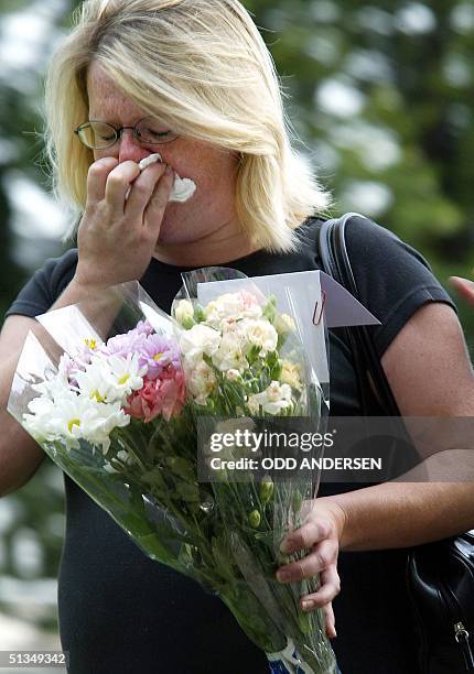 An unidentified woman weeps paying her last respect to Holly Wells and Jessica Chapman by putting down flowers outside the Church in the...