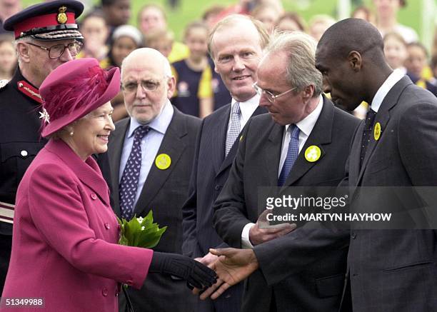 Britain's Queen Elizabeth II shakes hands with Sol Campbell of Arsenal FC, as Sweden' Sven-Goran Eriksson, the England soccer team manager introduces...