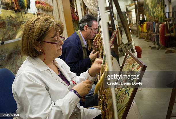 Pilar Felguera and Jose Antonio Carbajal work on a tapestry for rebuilt Residenzscholss in Dresden at the Royal Tapestry Factory on March 3, 2016 in...