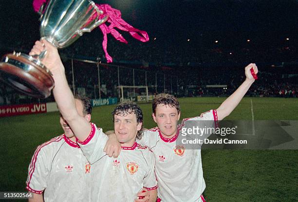 Manchester United striker Mark Hughes celebrates with the trophy with team mates Mike Phelan and Steve Bruce after the 1991 European Cup Winners Cup...