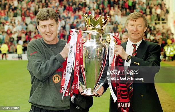 Manchester United coach Brian Kidd and manager Alex Ferguson celebrate with the premiership trophy after winning the 1995/96 title after the FA...