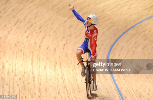 Steve Burke of Britain celebrates after Britain won gold in the final of the men's team pursuit at the 2012 Track Cycling World Championships in...