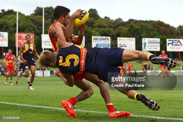 Jack Martin of the Suns gets atckled by Brad Sheppard of the Eagles during the 2016 AFL NAB Challenge match between the West Coast Eagles and the...