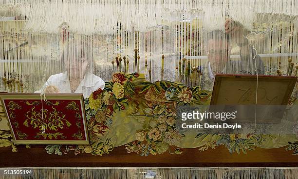 Pilar Felguera and Jose Antonio Carbajal work on a tapestry for rebuilt Residenzschloss in Dresden at the Royal Tapestry Factory on March 3, 2016 in...
