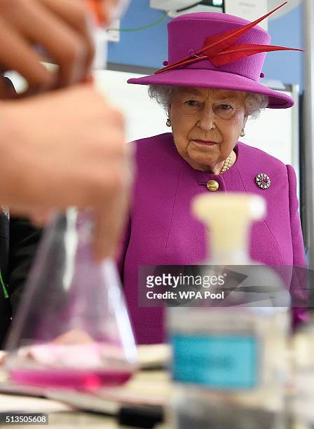 Queen Elizabeth II watches a chemistry lesson during a Queen's Trust visit to the Lister Community School in Plaistow on March 3, 2016 in London,...