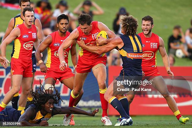 Daniel Currie of the Suns gets tackled by Matt Priddis of the Eagles during the 2016 AFL NAB Challenge match between the West Coast Eagles and the...