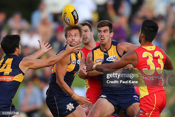 Liam Duggan of the Eagles looks to receive the ball from Mark LeCras and Scott Lycett during the 2016 AFL NAB Challenge match between the West Coast...