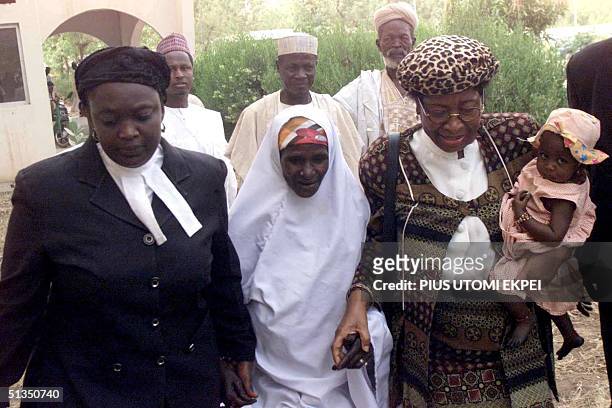 Female lawyers Ladidi Abdulkadir and Clara Obazele leads Safiya Husseini and her little daughter, Adama into Sokoto's State Sharia Court of Appeal,...