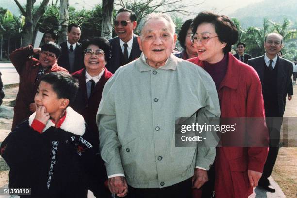 China's paramount leader Deng Xiaoping surrounded by his daughters Deng Lin , Chiah Lin , Deng Rong and grandson takes a walk in January 1992 during...