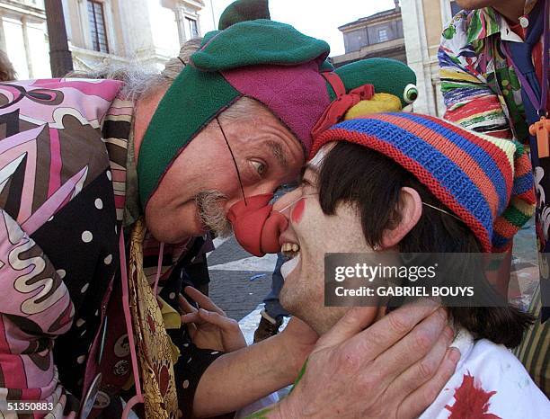 Dr. Hunter "Patch" Adams , founder of the Gesundheit Institute , a medical center in West Virginia, jokes with another clown-doctor during a...