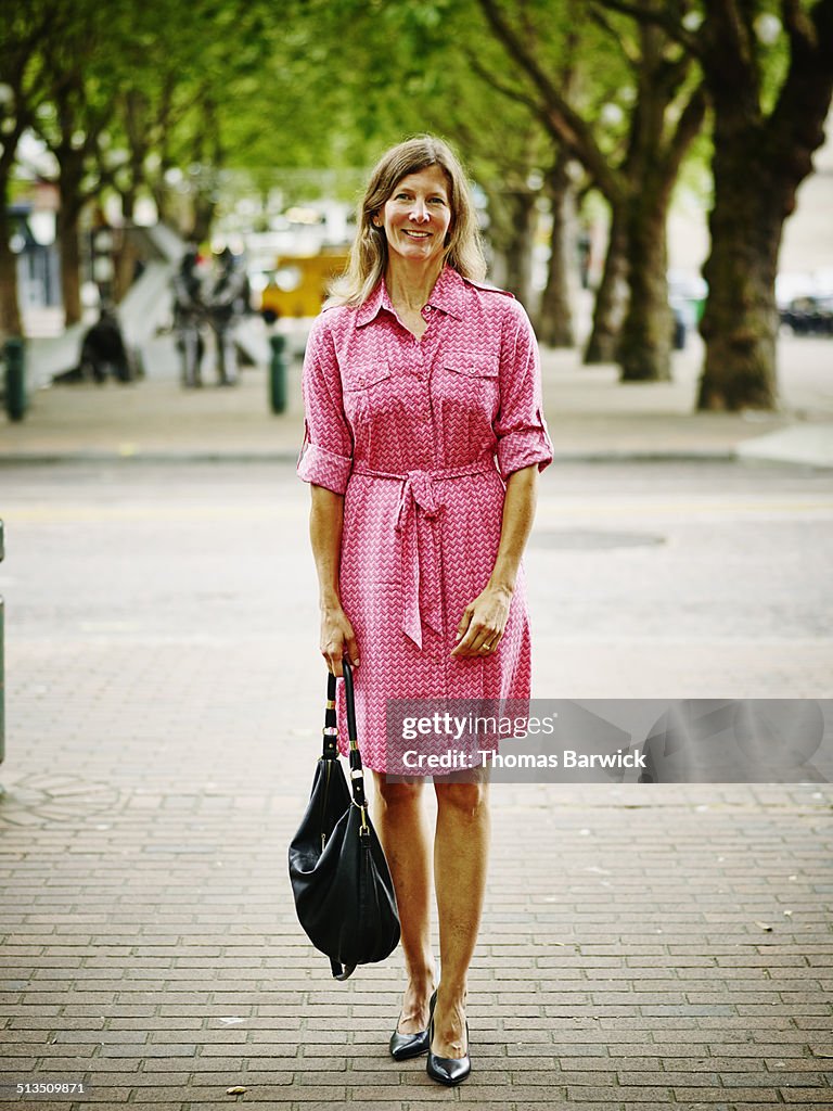 Businesswoman standing on sidewalk