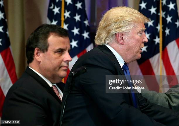 New Jersey Governor Chris Christie accompanies Republican Presidential frontrunner Donald Trump off the stage after a press conference on Super...