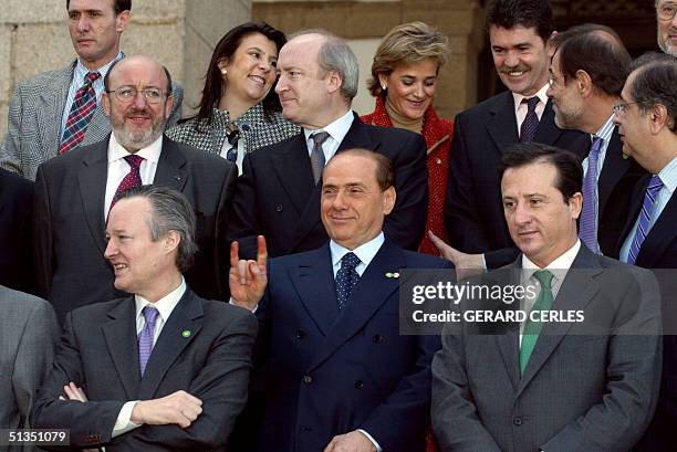 Italian Prime Minister and current Foreign Affairs minister Silvio Berlusconi makes a joke behind Spanish Foreign minister Josep Pique whose country...
