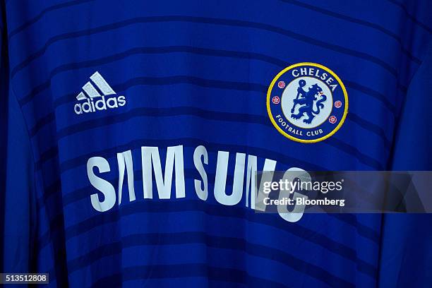 Samsung Electronics Co. Sponsorship logo sits on a Chelsea Football Club soccer shirt inside the Adidas AG store at the company's headquarters in...