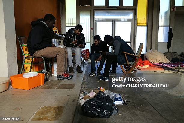 This photo shows migrants in the premises of a former church where sixty of them, hoping to take a ferry from Cherbourg to Portsmouth in Britain,...