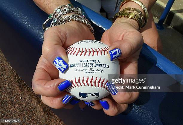 Fan with her fingernails painted with Yankee logos holds an official baseball prior to the Spring Training game between the Detroit Tigers and the...