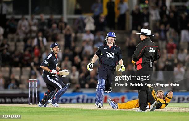 Eoin Morgan of England brings up his century and the win for England as Ryan Harris of Australia lies on the ground during the NatWest Series One Day...