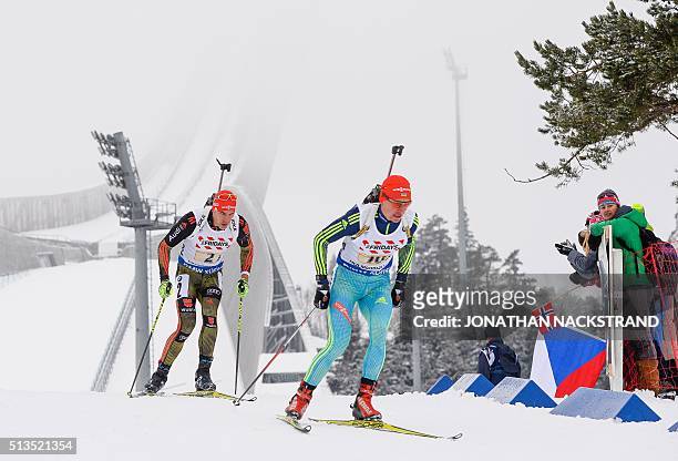 Ukraine's Sergey Semenov and Germany's Arnd Peiffer compete in the 2x6 + 2x7,5 mixed relay event at the IBU World Championships Biathlon competition...