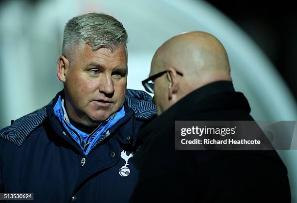 Spurs coach Nigel Gibbs speaks with Reading first team manager Brian McDermott during the Barclays U21 Premier League match between Reading U21 and...