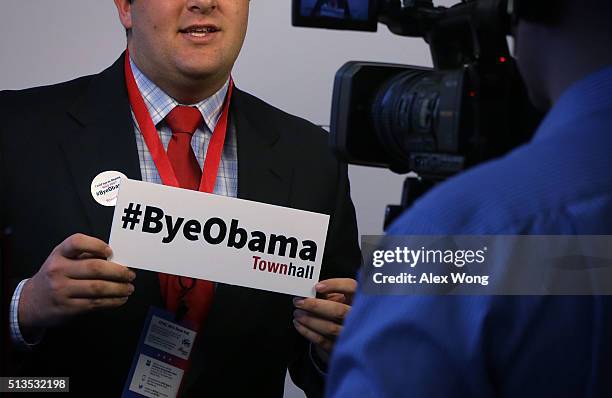An attendee tapes a farewell video message to President Barack Obama during the Conservative Political Action Conference March 3, 2016 in National...
