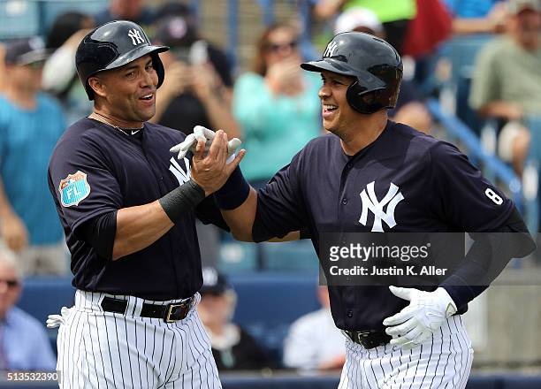 Alex Rodriguez of the New York Yankees celebrates with Carlos Beltran after hitting a two run home run in the first inning during the game against...