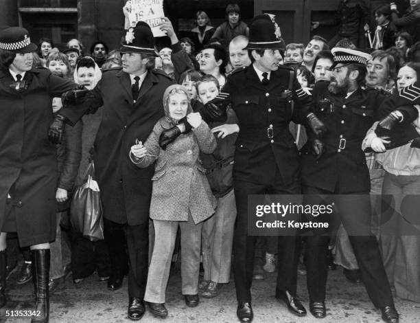 Police hold back crowds outside Dewsbury court, Yorkshire as Peter Sutcliffe appears in court after his arrest in connnection with the 'Yorkshire...