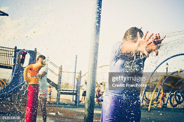 children playing at a waterpark. - girls and boys playing in waterpark stock-fotos und bilder