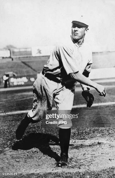 Picture shows American baseball pitcher Christy mathewson in the follow through of a pitch, 1900s. Methewson was an original inductee into the...