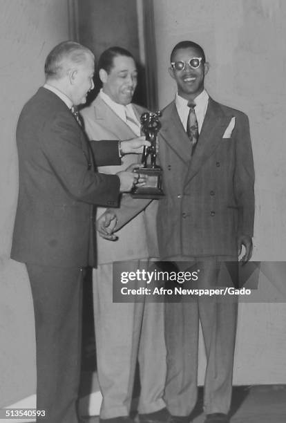 African-American composer, pianist, bandleader and Jazz musician Duke Ellington and Arthur Fiedler holding a trophy, 1960.