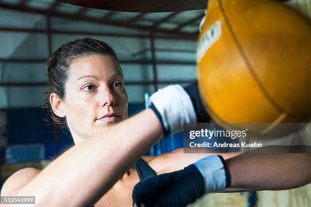 young woman doing a speed bag boxing workout. - punching ball stock pictures, royalty-free photos & images