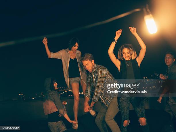 teenager friends dancing and laughing on a rooftop party - rooftop at night bildbanksfoton och bilder