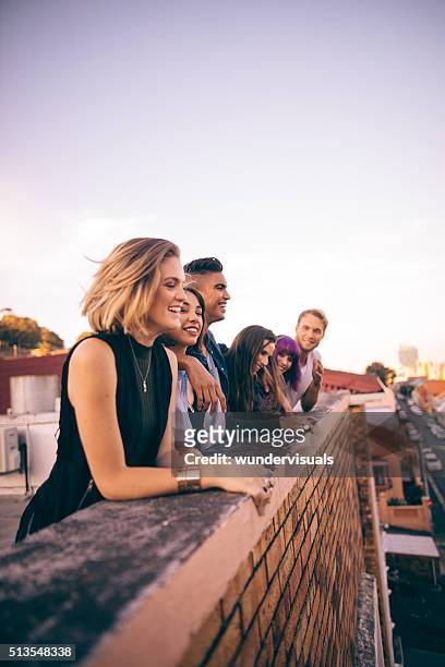 group of friends having a summer rooftop party at sunset - castle wall bildbanksfoton och bilder