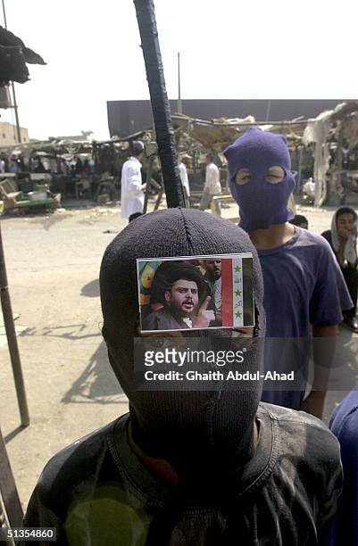 Shiite boys wearing ski masks brandish wooden sticks made to look like RPG launchers as thousands of Iraqi Shiites loyal to the radical cleric...