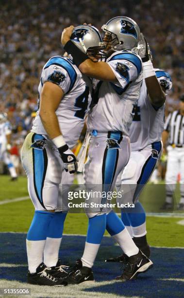 Jake Delhomme of the Carolina Panthers celebrates as he hugs teammate Brad Hoover during the game against the Green Bay Packers at Bank of America...