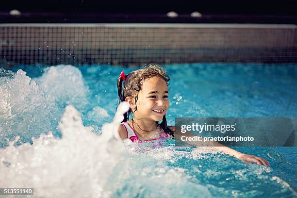 swimming pool games - girls in hot tub stockfoto's en -beelden