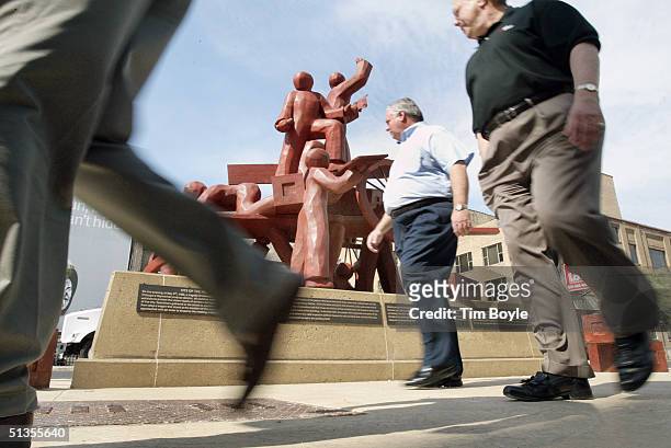 People walk near the Haymarket Memorial September 24, 2004 in Chicago, Illinois. The memorial marks the spot of Haymarket riot of 1886 where 11...