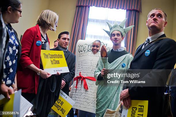 Kyle Epstein, dressed as the Statue of Liberty, and Corrina Qualls, in the Constitution, along with members of Generation Progress, deliver VHS...