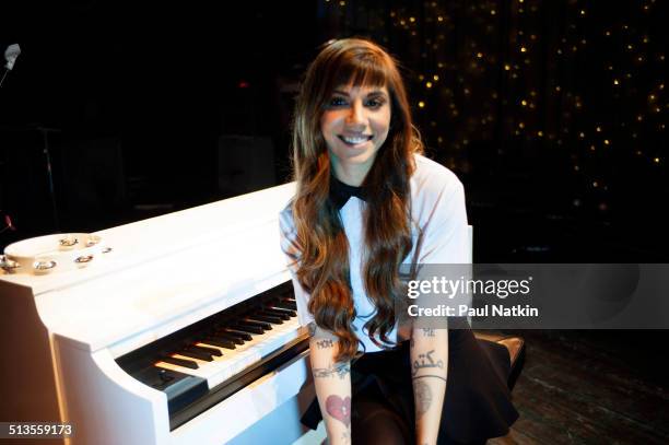 Portrait of American musician Christina Perri as she poses with a piano at the House of Blues, Chicago, Illinois, April 9, 2014.