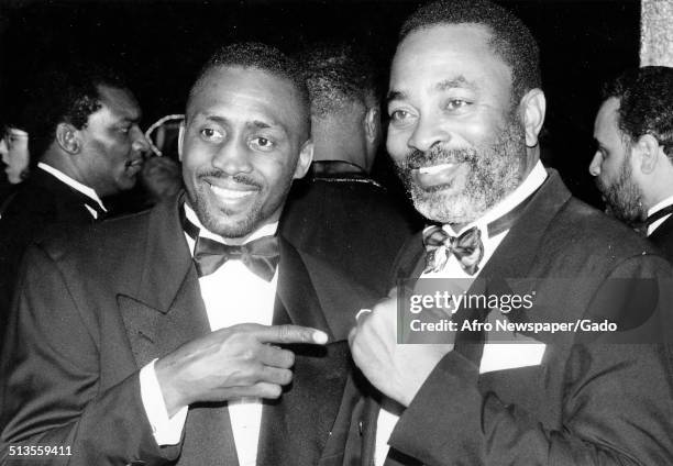 Boxer Thomas Hearns, left, and Lloyd Nash posing at a United Negro College Fund event, 1980.