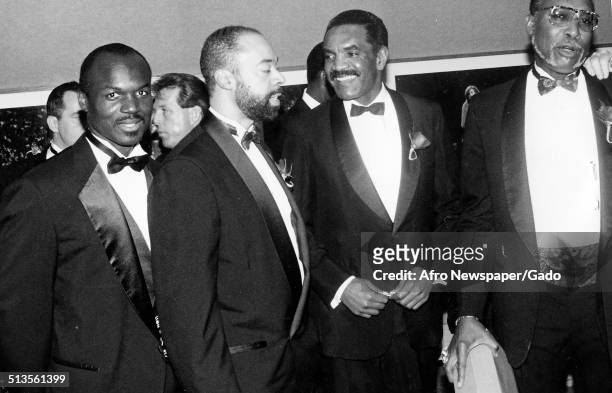 African-American man receiving an award at a United Negro College Fund event during a banquet, 1980.