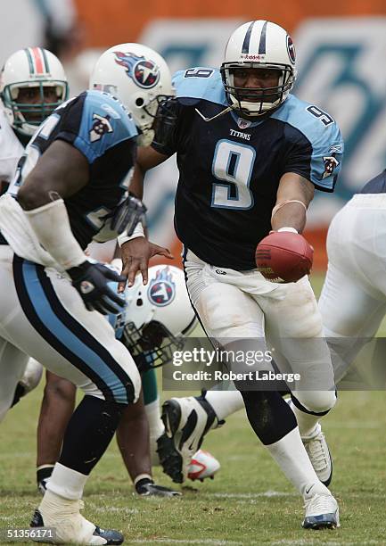 Quarterback Steve McNair of the Tennessee Titans makes a hand-off during the game against the Miami Dolphins at Pro Player Stadium on September 11,...