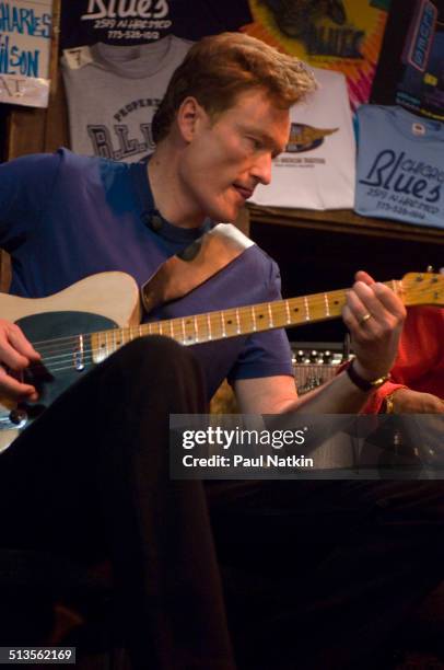 American comedian and television host Conan O'Brien plays the guitar at the BLUES nightclub, Chicago, Illinois, April 19, 2006.